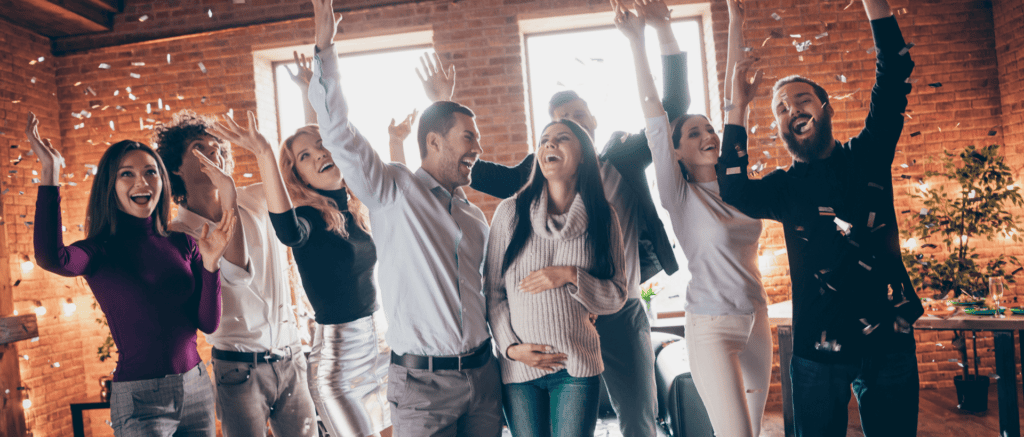 A group cheering and celebrating a baby shower at Bertucci's