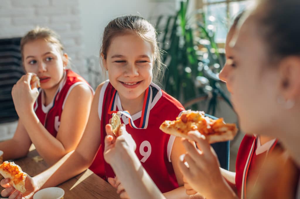 Kids with their sports team eating Bertucci's pizza
