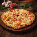 Shrimp Bella Venezia pizza topped with tender shrimp, diced tomatoes, fresh herbs, and melted mozzarella on a wood-fired crust, served on a wooden board.