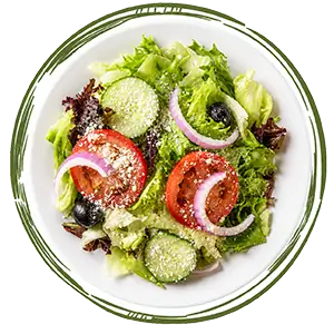 Fresh salad with tomatoes, cucumbers, red onion, black olives and grated cheese in a white bowl.