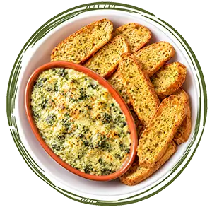 Spinach and artichoke dip with toasted flatbread on a plate.