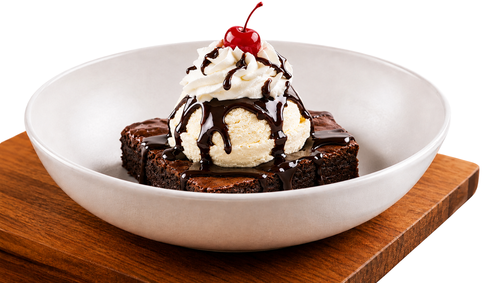 Bertucci’s brownie sundae with vanilla ice cream, chocolate sauce, whipped cream, and a cherry served in a white bowl on a wooden board.