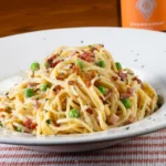 A huge portion of carbonara on a white plate