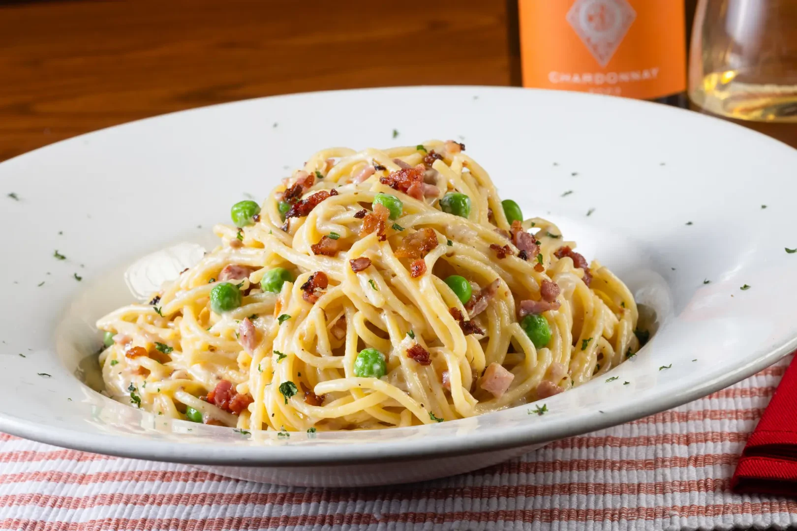 A huge portion of carbonara on a white plate